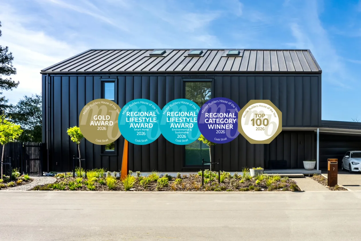 Exterior of the award-winning Greytown new build by Scotty's Construction, a dark board-and-batten home with a standing seam roof, overlaid with five Master Builders House of the Year 2026 badges: Gold Award, Regional Lifestyle Award (Smart Home), Regional Lifestyle Award (Environmental & Sustainable), Regional Category Winner, and Top 100