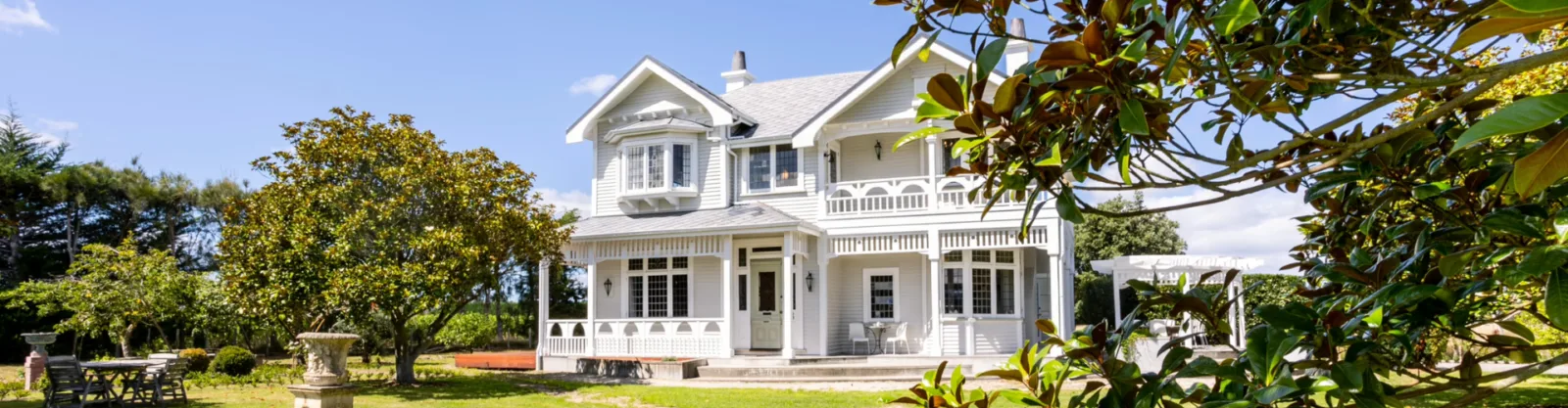 A photo of a beautiful white heritage style villa